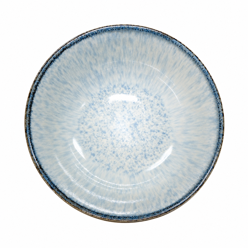 Overhead view of a deep pale blue and white noodle bowl with fine radiating interior detail and a narrow dark rim.