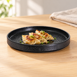 MT265-BK black round plate with dumplings on a wooden table