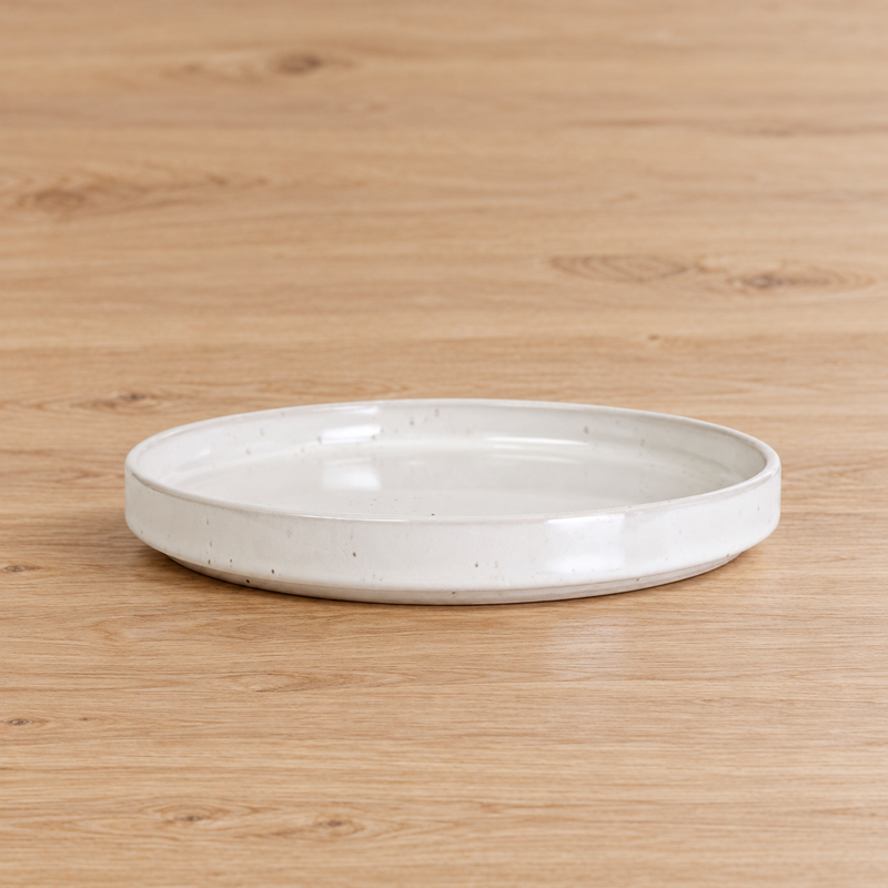 MT265-WH empty white shallow plate on a pale wooden table