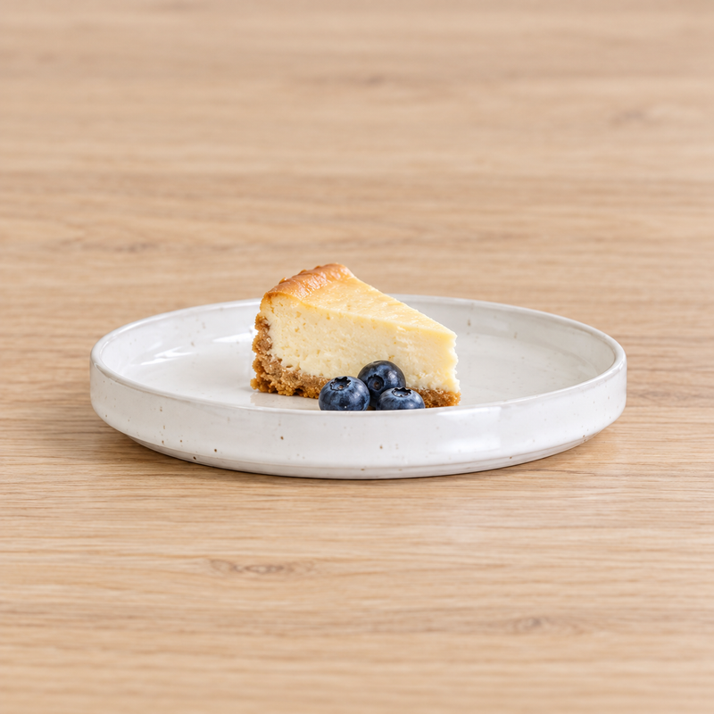 MT265-WH white shallow plate serving a petite cheesecake slice and blueberries