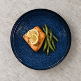 MT280-NB navy blue round plate with a modest salmon and green bean serving