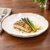 Beige brown-rim ceramic dinner plate with grilled fish and asparagus