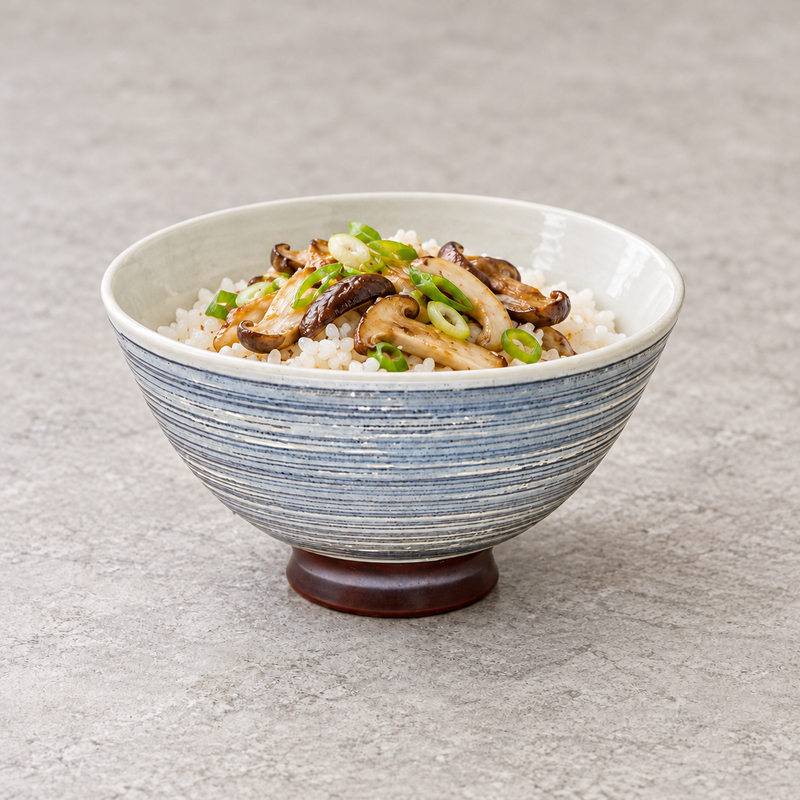 MT55-LBK striped bowl with rice, sliced brown mushrooms and green scallions; no utensil or other dish is shown.