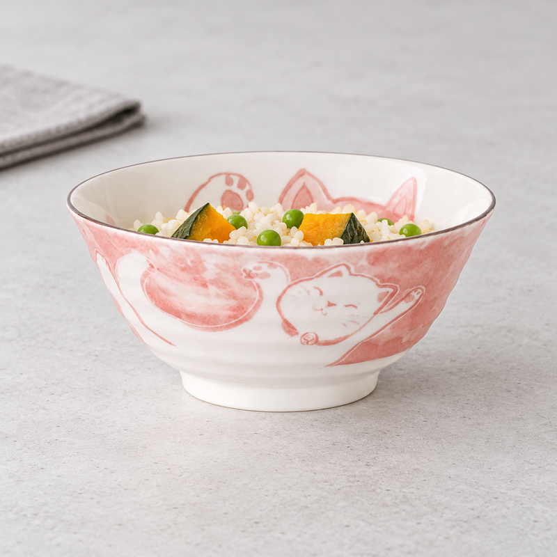 MT56-MCR pale pink cat bowl holding rice with green peas and orange squash pieces on a light tabletop