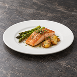 White broad-rim porcelain dinner plate with salmon and vegetables