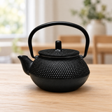 NTB64-10 black cast iron teapot on a dining table