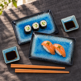 Blue and black porcelain plate set with sushi and soy sauce