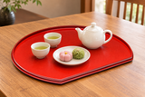 Red side of OS16-M reversible half-moon lacquer tray with a small tea service, serving suggestion