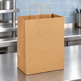 13 by 7 by 17 inch brown kraft paper bag with twisted handles on a brushed metal dispatch counter