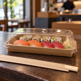 PH-07 kraft sushi tray with clear lid holding sushi on a restaurant counter