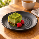 Six-inch black ripple-center melamine plate with a small matcha cake and raspberries
