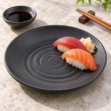 Six-inch black ripple-center melamine plate with two nigiri sushi pieces