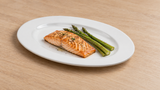 RCN-13 white porcelain oval plate with fish and vegetables on a dining table
