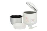 Narita NRC-100F rice cooker with lid open, removable inner pan, steam tray, measuring cup and spatula