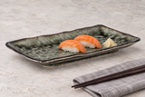 RT2112-GI green rectangular porcelain platter with salmon nigiri on a light table