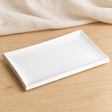 White rectangular porcelain plate in a natural tabletop setting