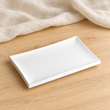 White rectangular porcelain plate in a natural tabletop setting