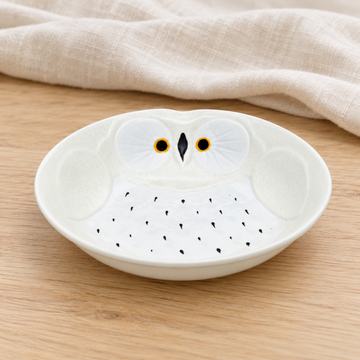 White owl design dish in a natural tabletop setting