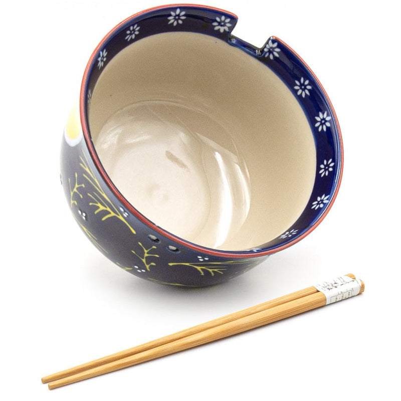 Blue rabbit and yellow moon bowl showing pale interior, floral band and chopstick-rest notches