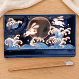 Rabbit design divided plate with included chopsticks in a natural tabletop setting