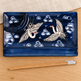 Crane design divided plate with included chopsticks in a natural tabletop setting