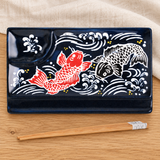 Fish design divided plate with included chopsticks in a natural tabletop setting