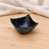 Black square dish in a natural tabletop setting