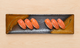 SP320-BK charcoal and ochre ceramic serving platter with a modest sushi arrangement