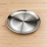SS-RP-9 satin stainless steel round plate on a dining table