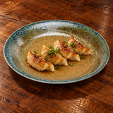 Gyoza on the green-blue and gold-brown 9½-inch porcelain plate