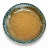 Overhead view of the green-blue and gold-brown 9½-inch porcelain round plate