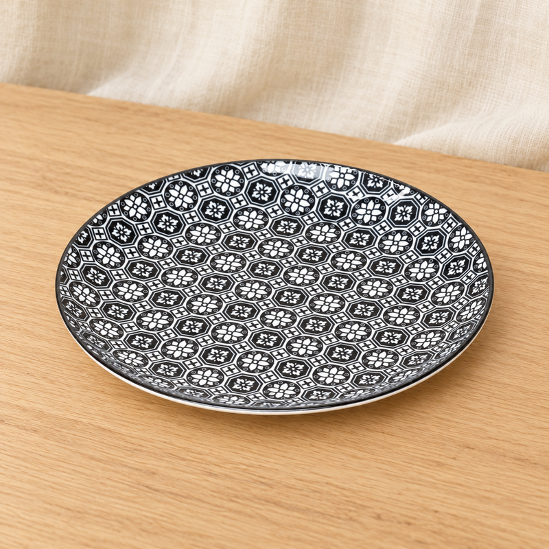 TN281-BK black geometric floral plate on a wooden tabletop