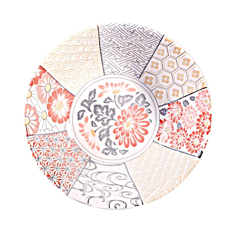 Overhead view of a coral floral bowl with a circular flower center and eight beige, gray and coral geometric and floral panels.