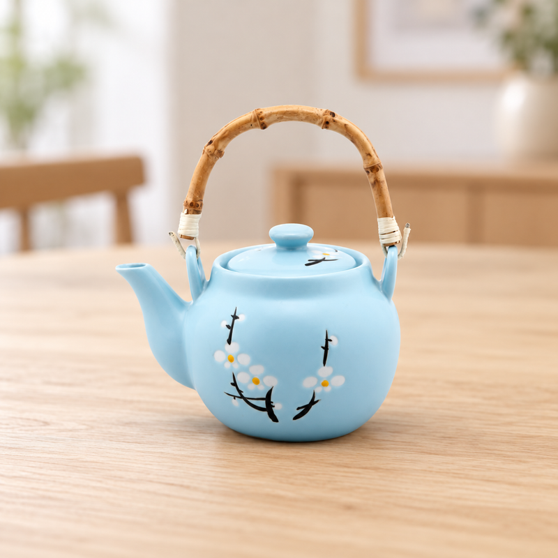 Pale blue blossom teapot in a tabletop tea setting