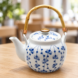 TP22 blue floral porcelain teapot with bamboo handle on a dining table