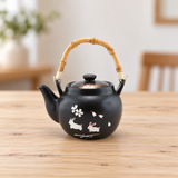 TP45 black rabbit-pattern teapot with bamboo handle on a dining table