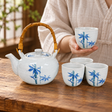 TPS123 blue bamboo tea set with one of four cups held for service