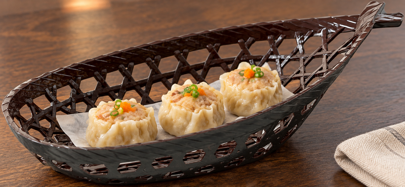 Brown boat-shaped basket with small dumplings
