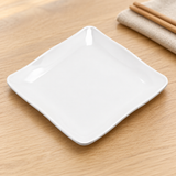 White square side dish on a dining table