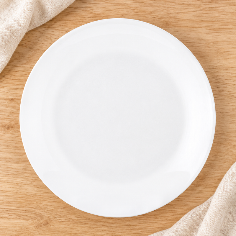 White round plate viewed overhead on a natural tabletop