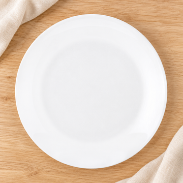 White round plate viewed overhead on a natural tabletop