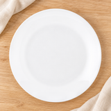 White round plate viewed overhead on a natural tabletop
