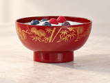 Red and gold bowl with yogurt and whole berries