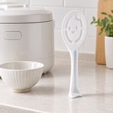 White rice paddle standing on its flared handle base