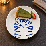 YG25-CT4 blue and white tabby cat ceramic plate with a petite matcha cheesecake slice