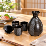 YW92-BK black patterned sake bottle and four cups in a restaurant tabletop setting