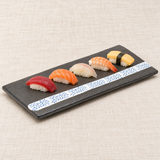 Gray arabesque ceramic platter with five nigiri