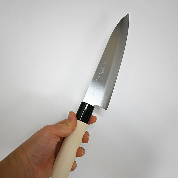 8218-A2 cooking knife held to show its blade-to-handle proportions