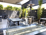 Gray open-back plastic restaurant chair; restaurant setting, other furniture illustrative