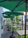Green open-back plastic restaurant chair; restaurant setting, other furniture illustrative